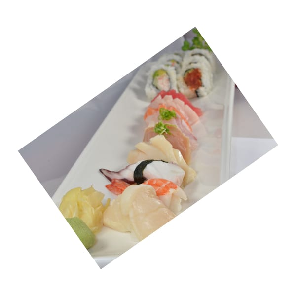 Hanabi Sushi platter with various sushi rolls, sashimi, and nigiri, served with ginger and wasabi.