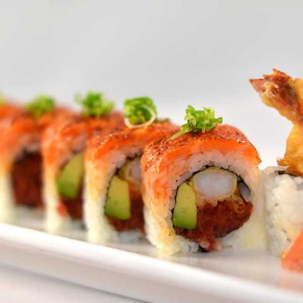 Hanabi Sushi's spicy tuna and avocado sushi rolls, topped with shrimp tempura and green onions.